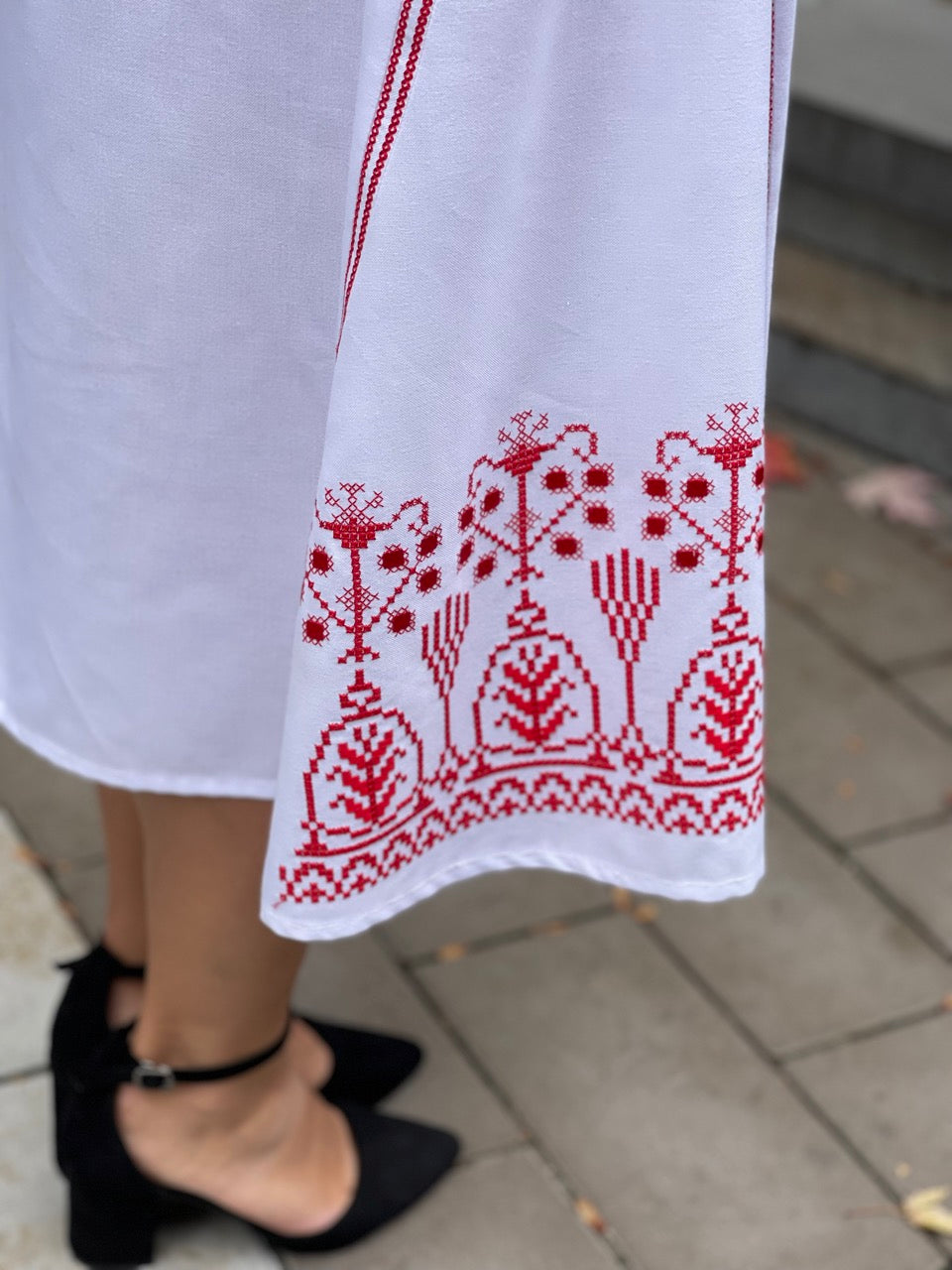 The White Dress with Red Embroidery