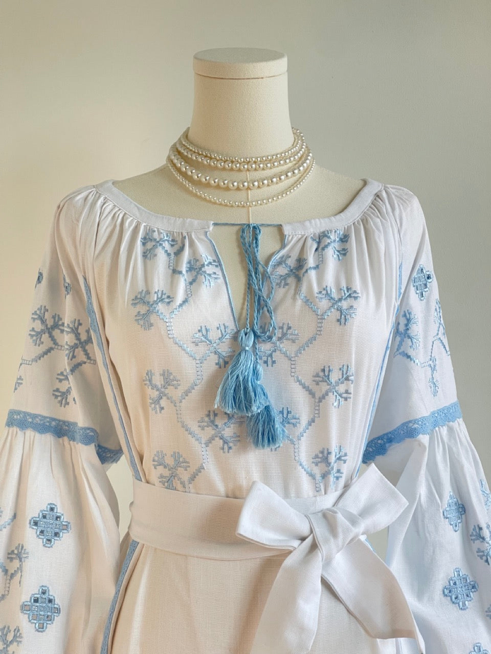 The White Dress with Blue Embroidery