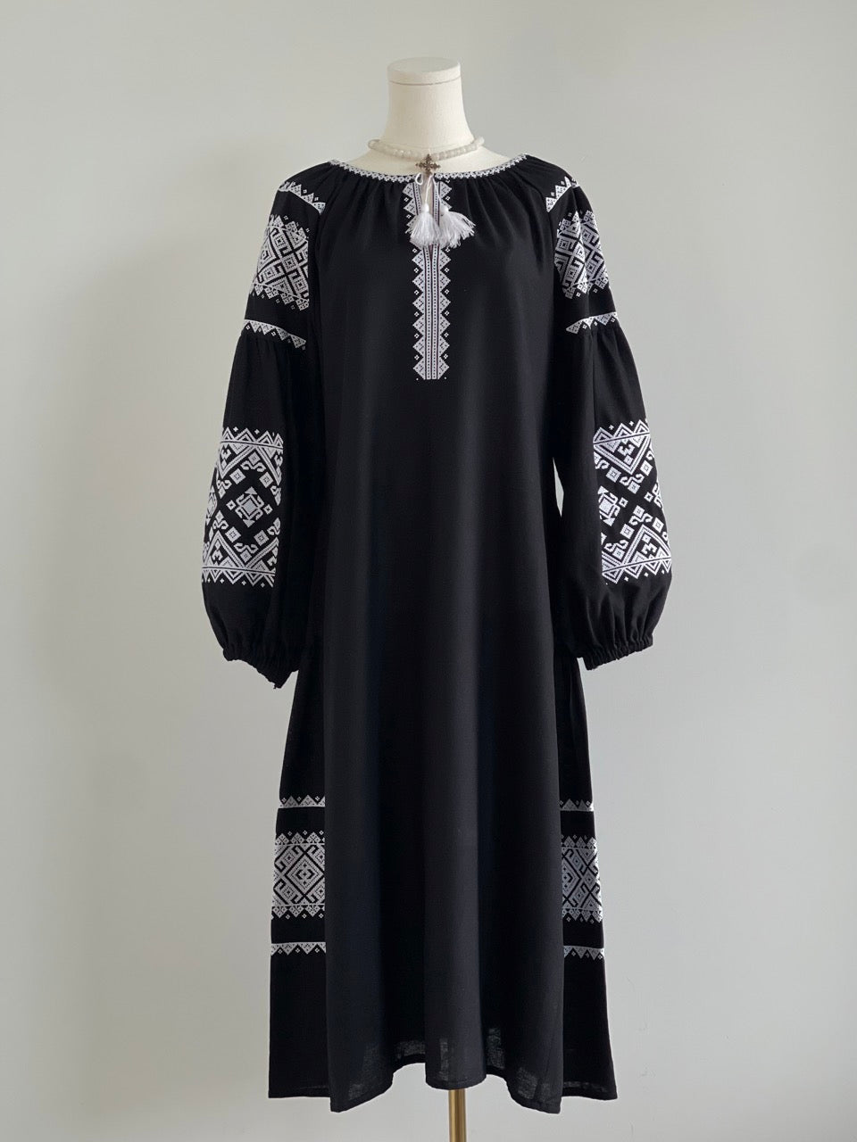 The Black Dress with White Embroidery